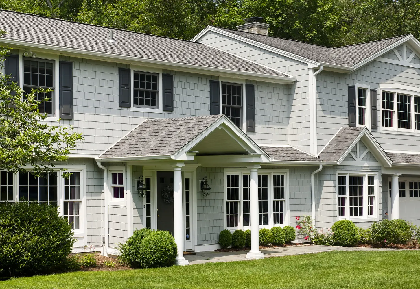 Large home finished in pale Light Mist horizontal lap siding