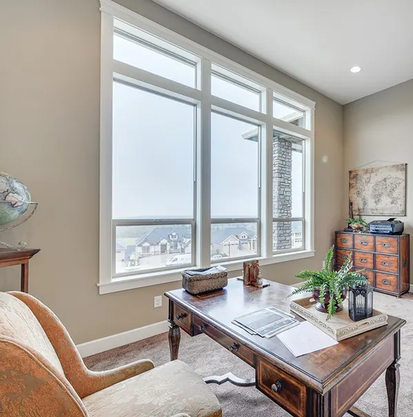 Finished room with a sharp view of white Milgard V250 Style Line single-hung windows
