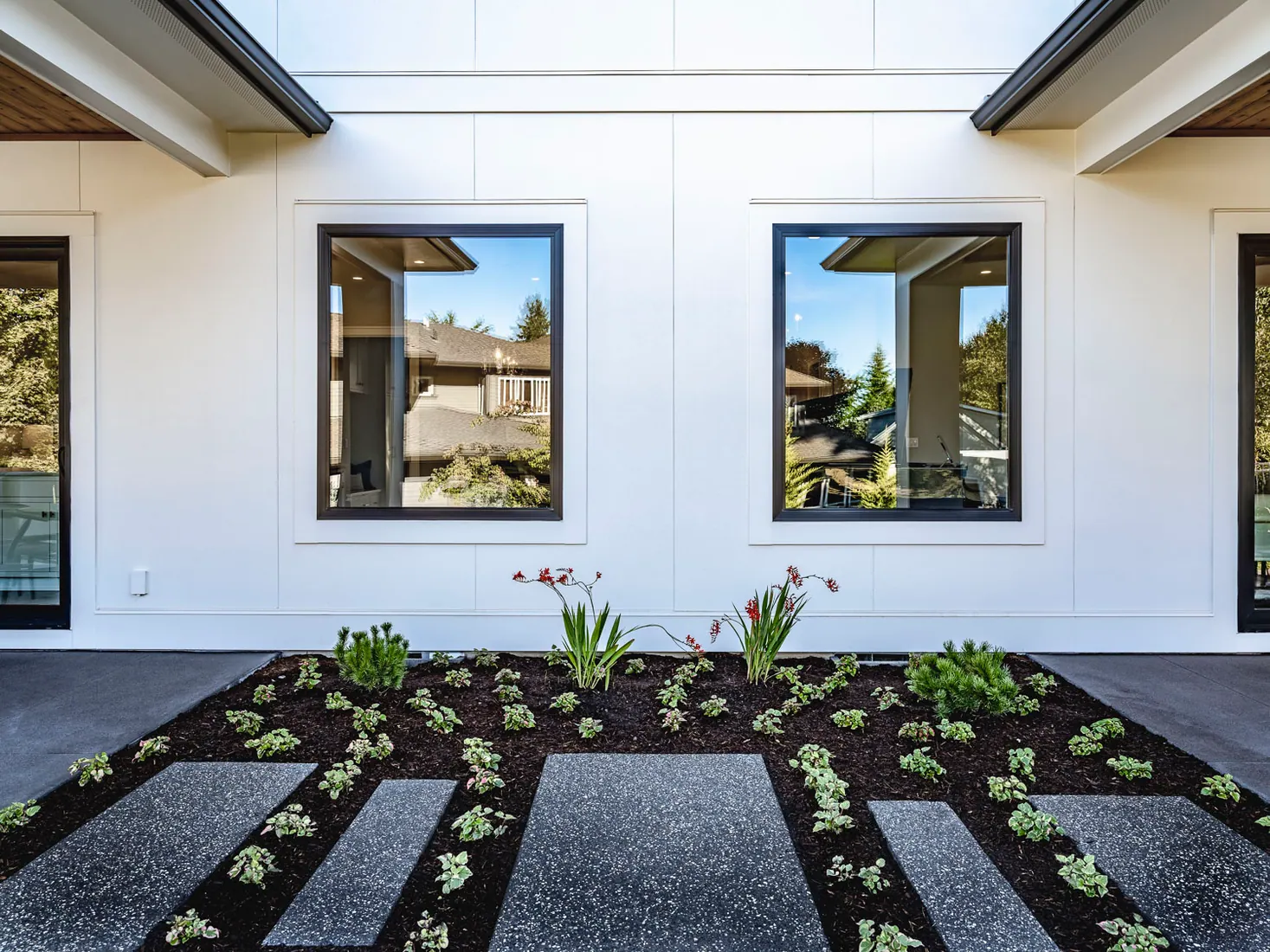 Contemporary white home with broad Fine Sand architectural siding panels