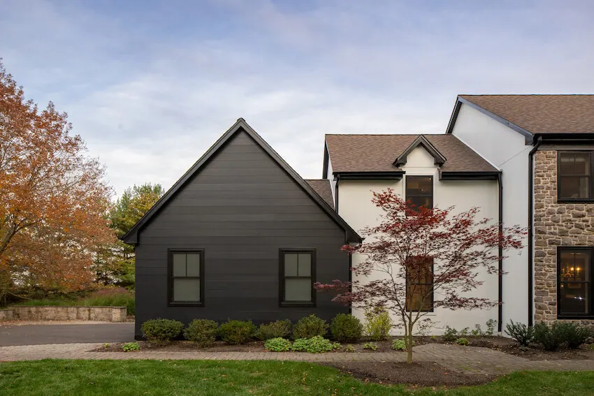 Modern gabled home using wide black architectural siding panels