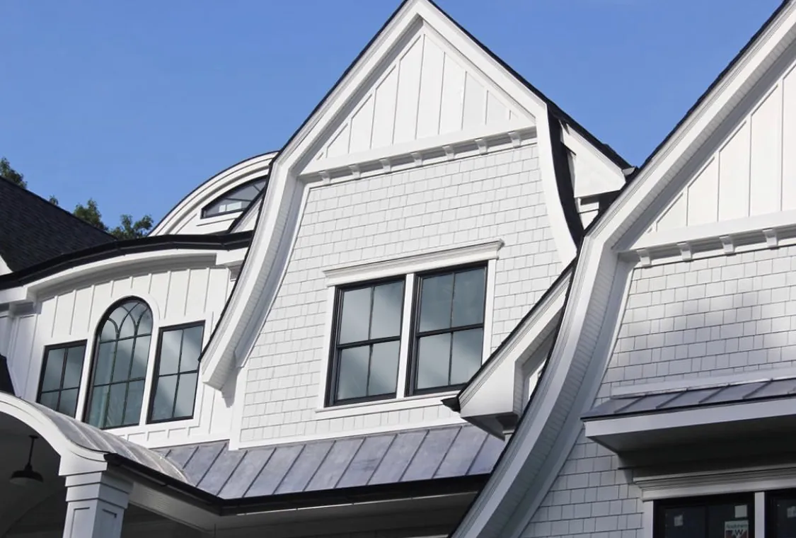 Close architectural view of Arctic White straight-edge shingle siding across multiple gables